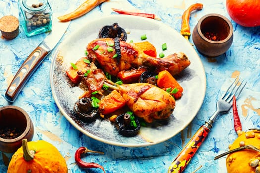Chicken legs baked with pumpkin. Thanksgiving Day.