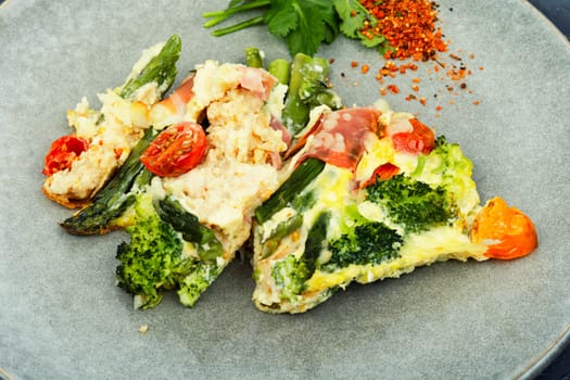 Asparagus wrapped in bacon with grated parmesan cheese