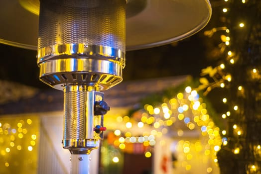 Design stainless steel metal gas burning indoor patio heater with blurred enteriour background
