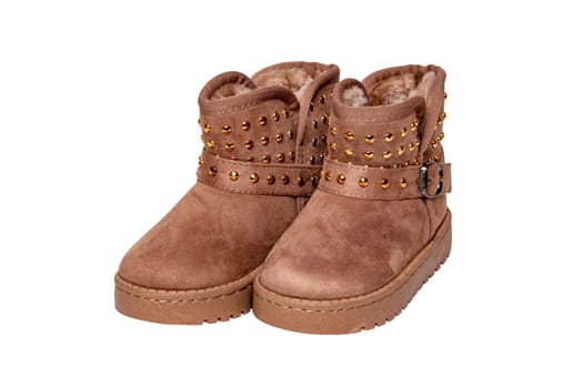 Winter boots for children. Close-up of a pair of elegant brown suede winter boots which are lined with fur. Girls winter shoe fashion new trends isolated on a white background.