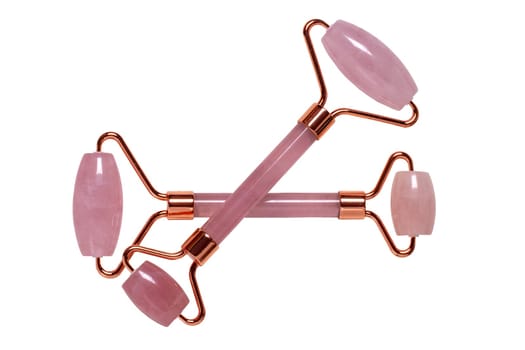 Gua Sha massage tools. Close-up of two pink jade facial roller or beauty roller for better blood circulation and muscle activation. Clipping path. Beauty concept. Isolated on white.