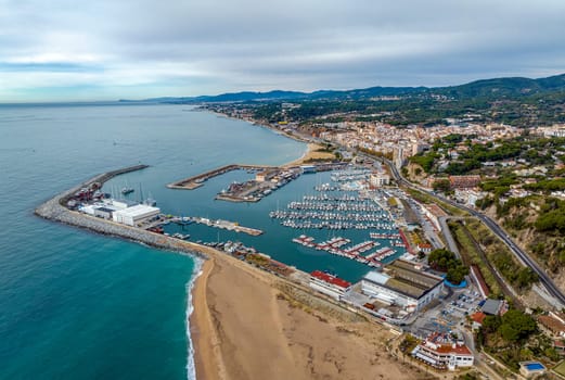 Aerial panoramic view of Arenys de Mar city at dawn. Located in El Maresme, Barcelona, Spain