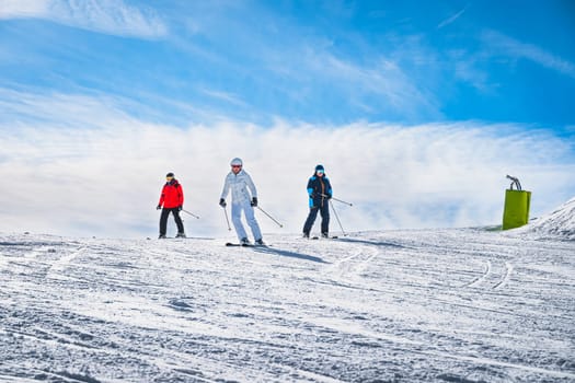 Man and woman skiing down the ski slope or piste in Pyrenees Mountains. Winter ski holidays in El Tarter, Grandvalira, Andorra