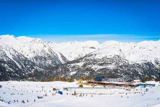 People, families, skiers and snowboarders relaxing and having fun in winter at Soldeu ski lifts cross centre, Grandvalira, Andorra, Pyrenees Mountains