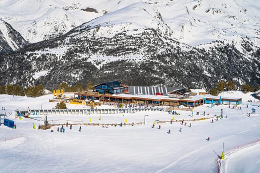 Winter sports and family ski holiday, view on Soldeu ski lifts cross centre with snowy mountains in background, Grandvalira, Andorra, Pyrenees