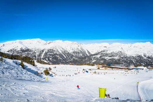 Family ski holiday, view on Soldeu ski lifts cross centre located in beautiful winter mountain range scenery, Grandvalira, Andorra, Pyrenees Mountains