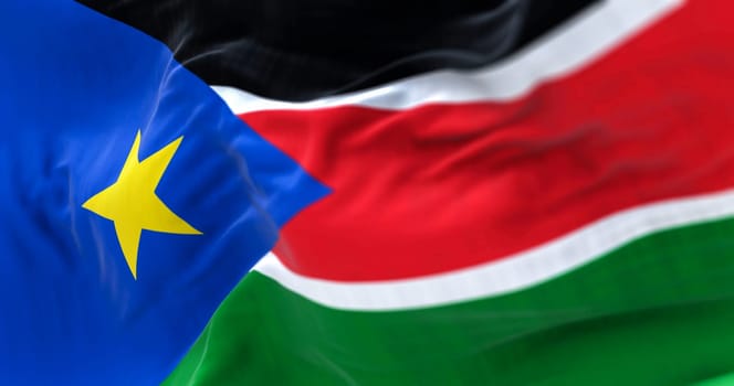Close-up view of the South Sudan national flag waving in the wind. The Republic of South Sudan is a country in Central Africa. Fabric textured background. Selective focus. 3d illustration