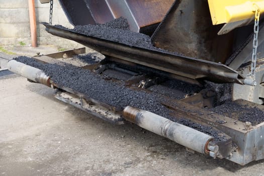Paver finisher, asphalt finisher or paving machine placing a layer of asphalt. Repaving