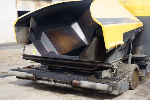 Paver finisher, asphalt finisher or paving machine placing a layer of asphalt. Repaving