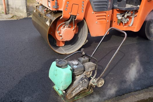 Heavy vibratory road roller close-up. Repaving the road surface. Road works