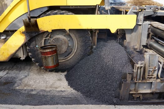 Paver finisher, asphalt finisher or paving machine placing a layer of asphalt. Repaving