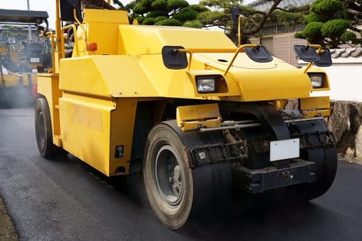 Heavy vibratory road roller close-up. Repaving the road surface. Road works