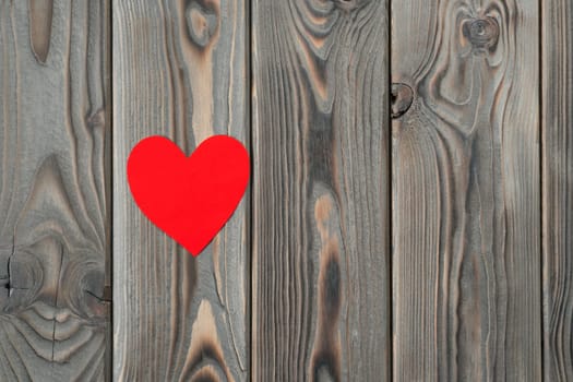 Little red heart shape on dark wooden background. Saint valentines, love greeting card and invitation on holidays. Happy marriage, wedding, 14 February or mothers day. Copy space, top view, flat lay