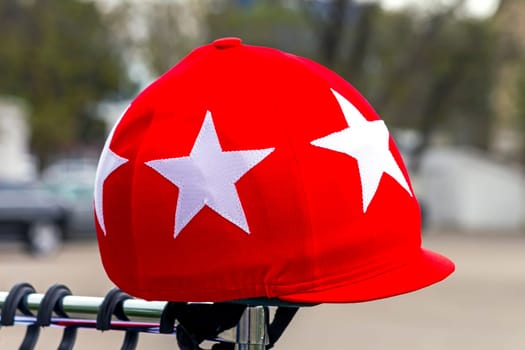 Jockey's headdress, red round cap.