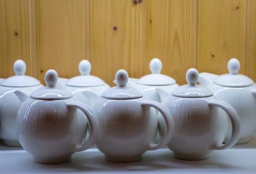 Many coffee pots stand side by side in one compartment.