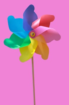 A plastic windmill with a wooden handle. Not a children's toy.