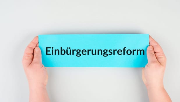 Naturalization reform is standing in german language on the paper, new law in Germany for immigrants and asylum seekers to receive citizenship