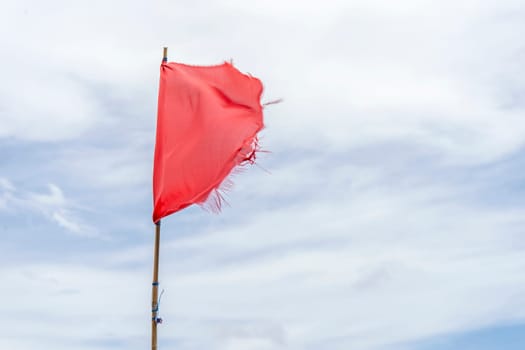 Red flag warning flags wind blue sky