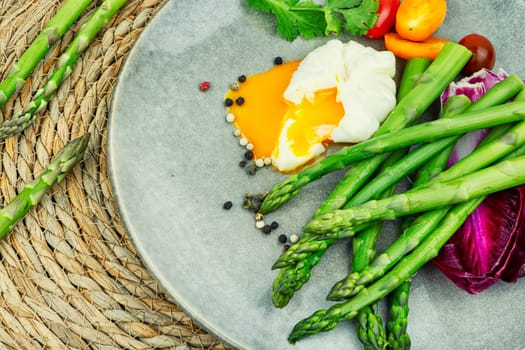 Salad with asparagus, lettuce, tomato and poached egg. healthy lunch