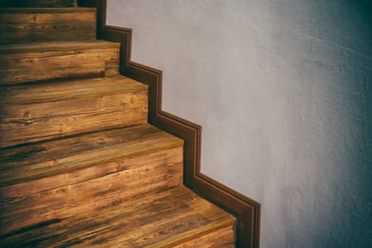 Wooden stairs climb up hardwood inside home