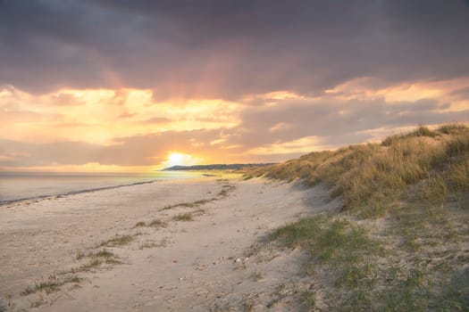 Beach crossing in Denmark by the sea. Dunes, sand water and clouds on the coast. Trip to the Baltic Sea. Vacation on the beach. Scandinavia landscape