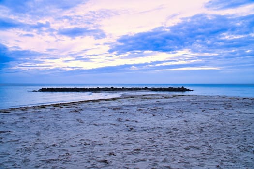 Hundested, Denmark on the cliff overlooking the sea. Baltic Sea coast, grassy meadow, beach. Clouds on horizon. Landscape photo from Scandinavia.
