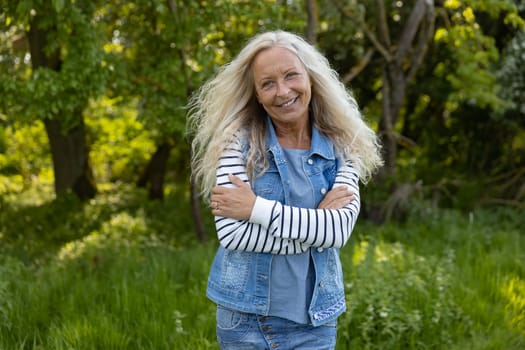 Beautiful Woman crossed her arms in a puplic park on a sunny day