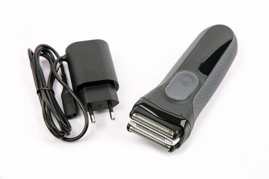 Power Adapter and Electric Shaver over bright background