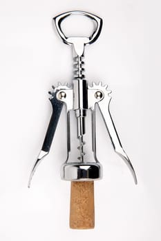 Wine opener with cork isolated over white background