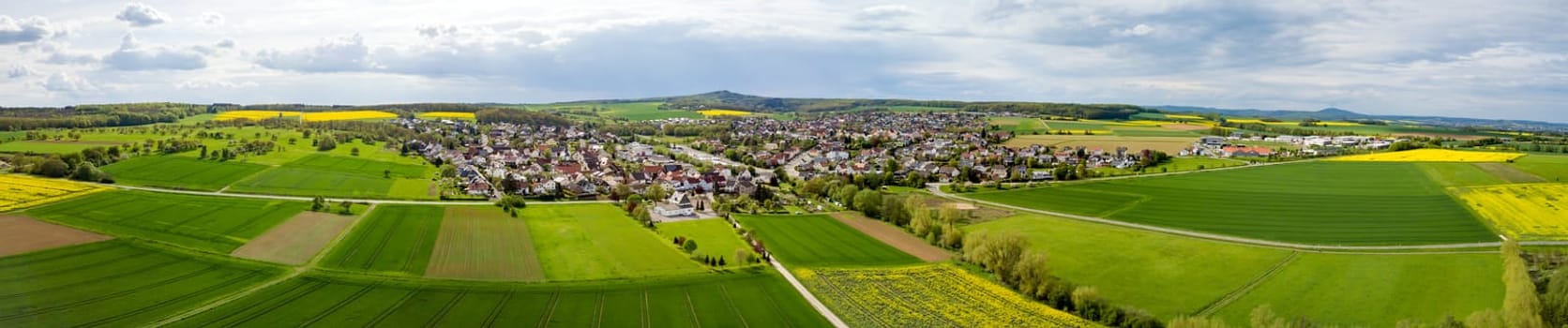 Panoramic Drone shot from german landscape with meadows and small village