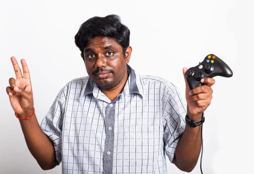 Asian happy portrait young black man funny use hand playing video game pad joystick controller, studio shot isolated on white background