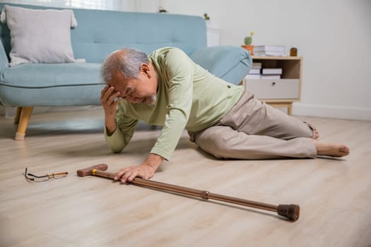 Older senior man headache lying on the floor after falling down he pain and hurt from osteoporosis, Elderly man falling on the floor alone with walking stick at home, Health care and medicine