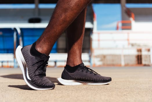 Asian young athlete sport runner black man wear feet active ready to running training at the outdoor on the treadmill line road for a step forward, healthy exercise workout, closeup back shoe