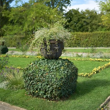 Planter with flower as decoration on a meadow in a public park in Germany