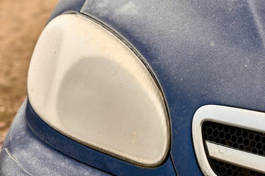 the front headlight of the car covered with frost. High quality photo