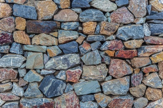 Natural colorful rust quarzite wall. Irregular shape stones