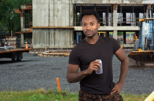 worker on break drinking soda at construction site job break tired man overworked