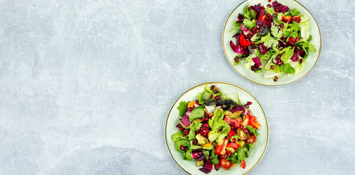 Vitamin salad with greens, pepper, radicchio and cucumber, decorated with pomegranate. Diet menu