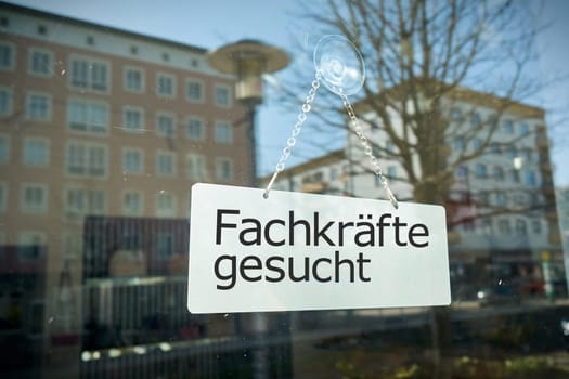 Sign on shop window with the german inscription Fachkrafte gesucht. Translation: Skilled workers wanted
