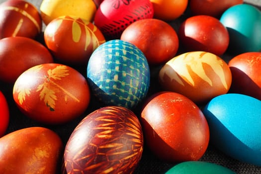 Multicolored Easter eggs. Lots of handmade eggs decorated at home. Ornament and painting on the shell. Happy Easter holiday. Symbol of life and spring. Poster or background for Easter