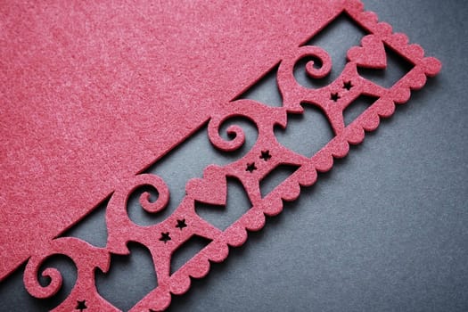 Background New Year's or for Valentine's Day. Kissing goats with stars and hearts are carved on red felt fabric. Merry Christmas and Happy New Year. Postcard, congratulation or invitation. Copy space.