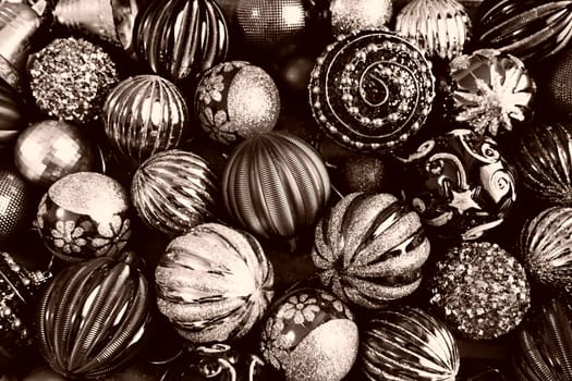 Christmas flat lay with Xmas decorations and holiday beautiful balls. Christmas tinsel. Happy New Year and Merry Christmas. Black and white monochrome photo with sepia filter. Still life background.