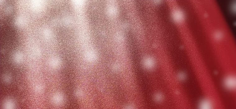 rays and white bokeh on a red background. New Year or Christmas background with white spots that look like snow. Blurred image