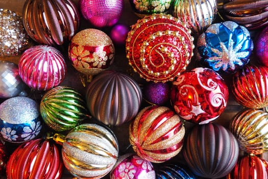 Christmas decorations. Beautiful red, golden, yellow balls with sparkles and stripes. Preparing for the New Year and Christmas holidays. Beautiful decorations. Flat lay and still life. Modern style
