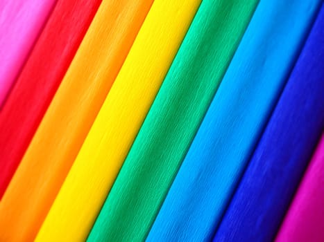 Pride Flag by Gilbert Baker. Symbol of the overall LGBTQ LGBTI community. Crepe paper is available in pink, red, orange, yellow, crepe, blue, purple and magenta. Colorful background for Pride events.