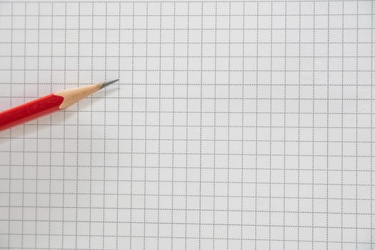 Pencil of red on the grid background