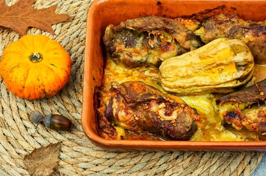 Appetizing baked meat rolls stuffed with pumpkin. Autumn recipe.