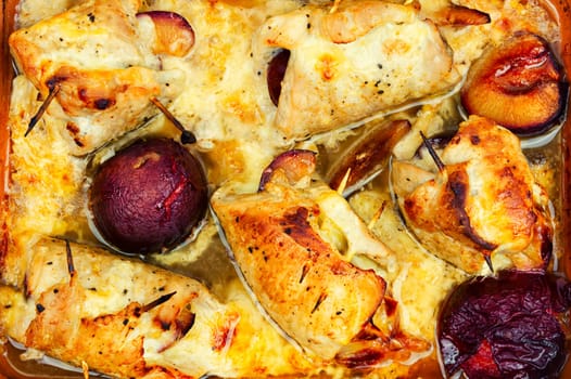 Appetizing meat rolls baked with plum filling on a plate