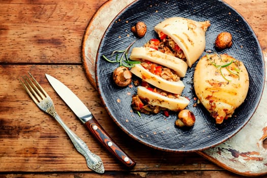 Grilled squids with vegetable stuffing. Stuffed calamari. Mediterranean food