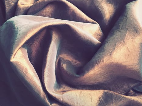 Beautiful fabric - taffeta, gently folded in waves. Crumpled material that looks like silk or brocade. Overflow and color gradient at different lighting angles. Fabric for sewing clothes and curtains.
